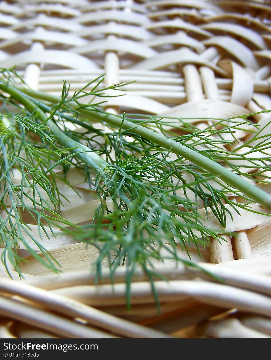 Dill in knitted basket in macro photography