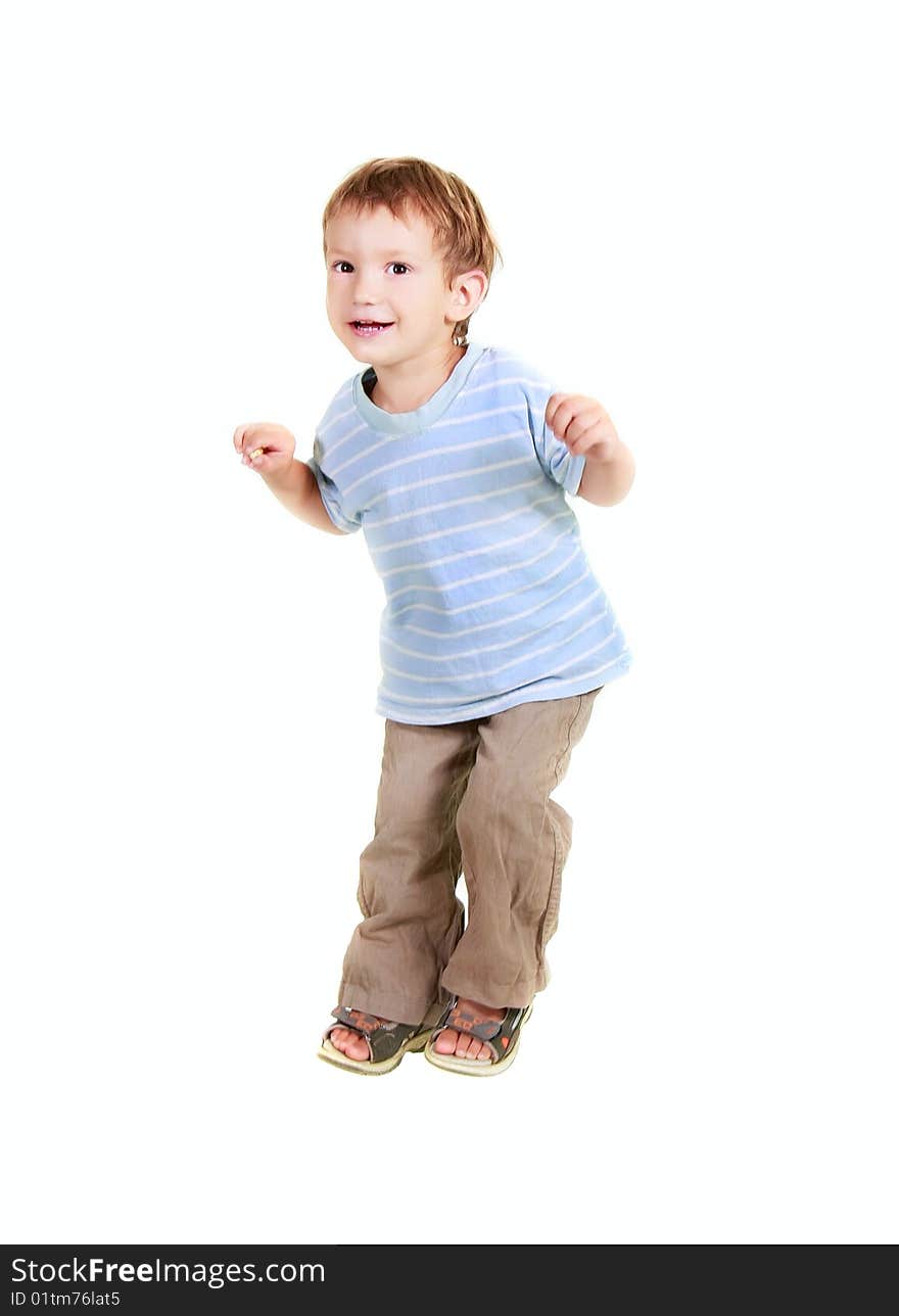 Happy young boy jumping over white