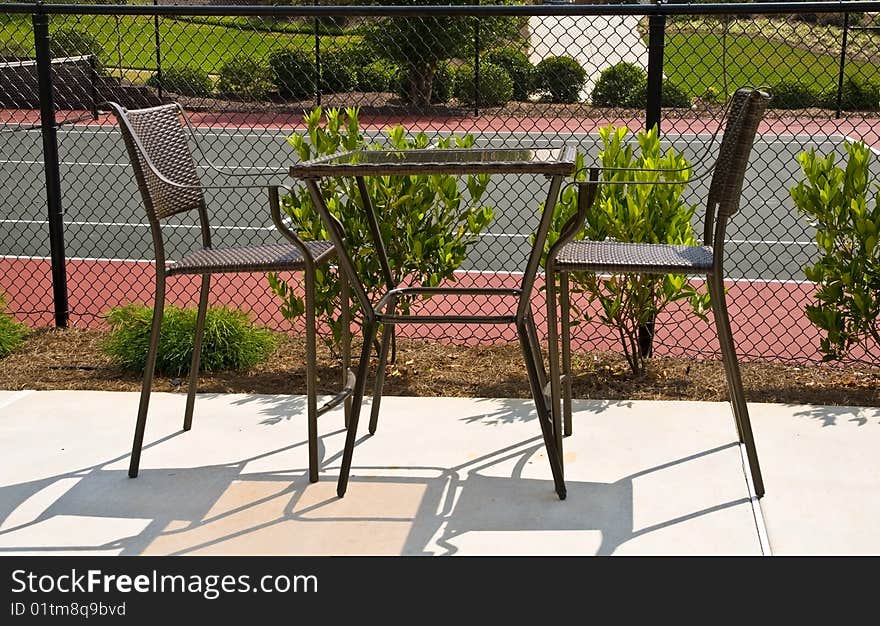 A table for 2 beside the tennis court. A table for 2 beside the tennis court.