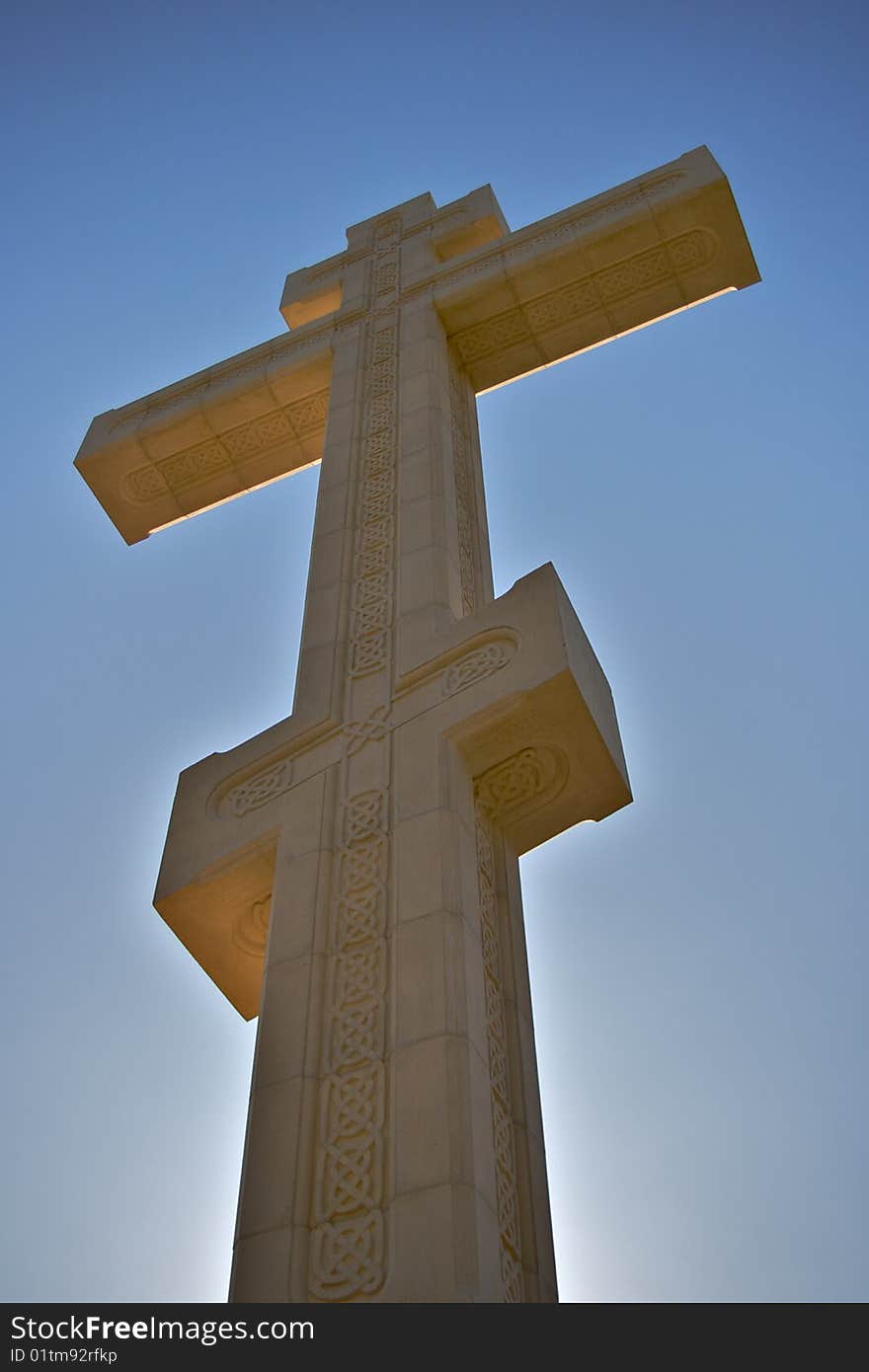 Old cross and sky, yellow limestone, fretwork. Old cross and sky, yellow limestone, fretwork