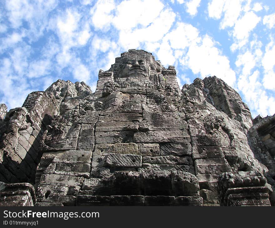Photo of an iconic face on the bayon temple near siem reap, cambodia. Photo of an iconic face on the bayon temple near siem reap, cambodia.