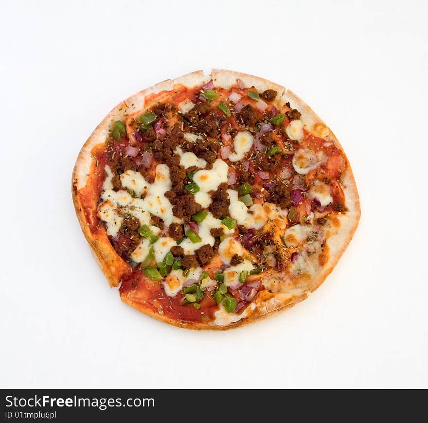 A pizza with spicy beef, green peppers and red onion isolated over a white tablecloth. A pizza with spicy beef, green peppers and red onion isolated over a white tablecloth