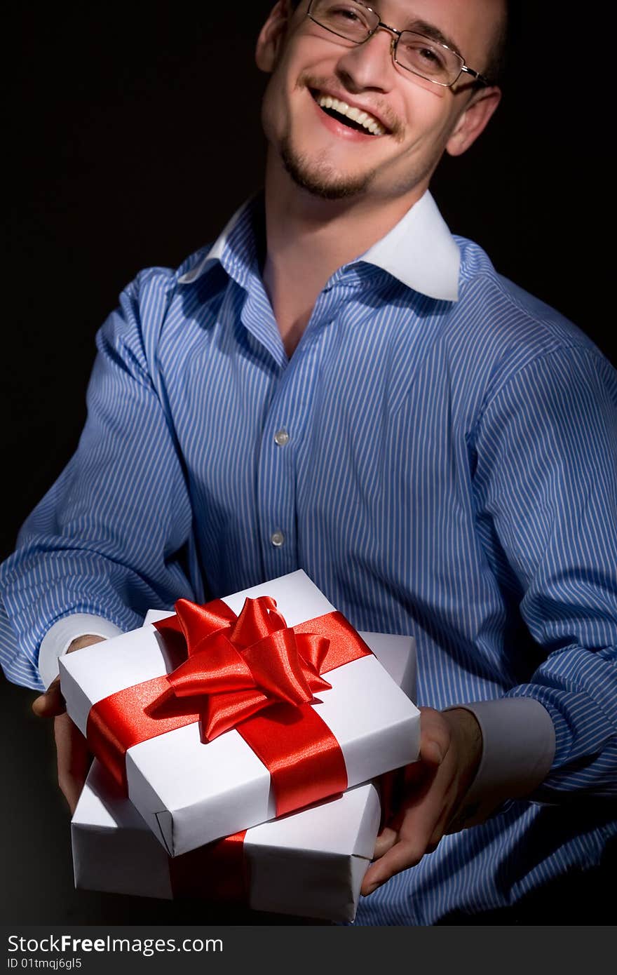 Smiling man holding fine wrapped gift box