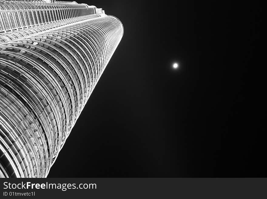 Bright moon in the sky next to the Twin Towers in Kuala Lumpur. Bright moon in the sky next to the Twin Towers in Kuala Lumpur.