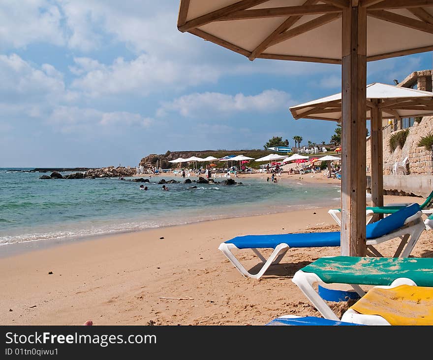 Summer vacation beach resort with umbrellas and colorful chairs