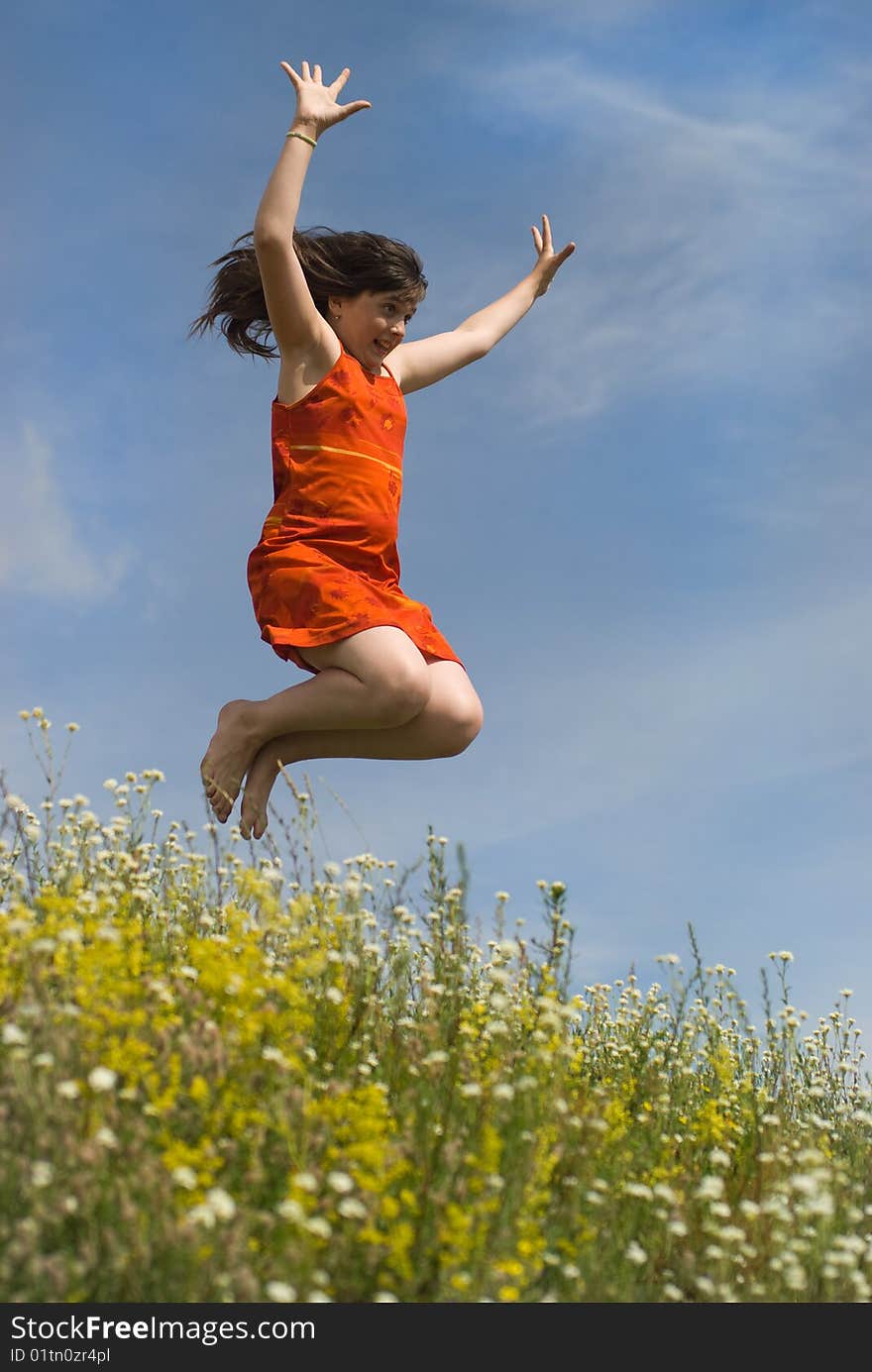 Jumping girl on the green hill (summer)