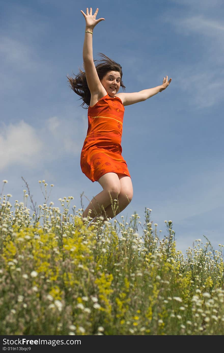 Jumping girl on the green hill (summer)