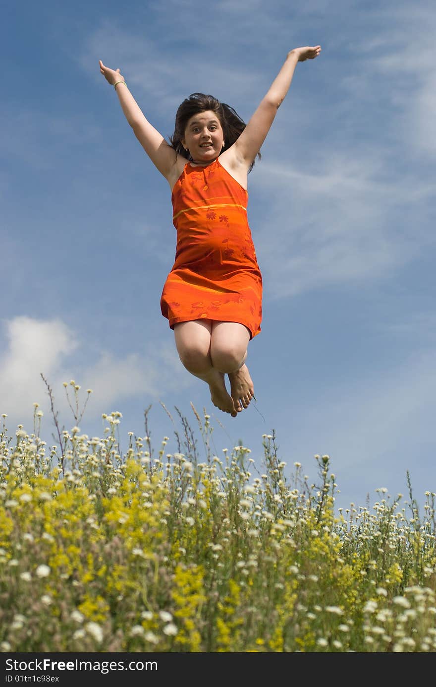 Jumping girl on the green hill (summer)