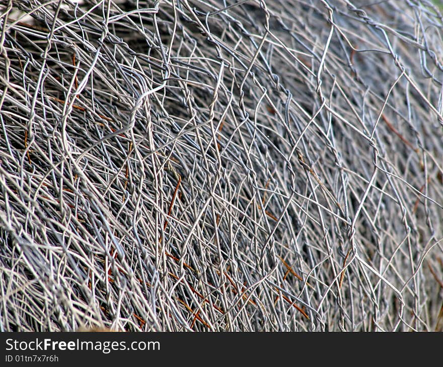 Sharp macro of a rolled metal wire fence. Sharp macro of a rolled metal wire fence.