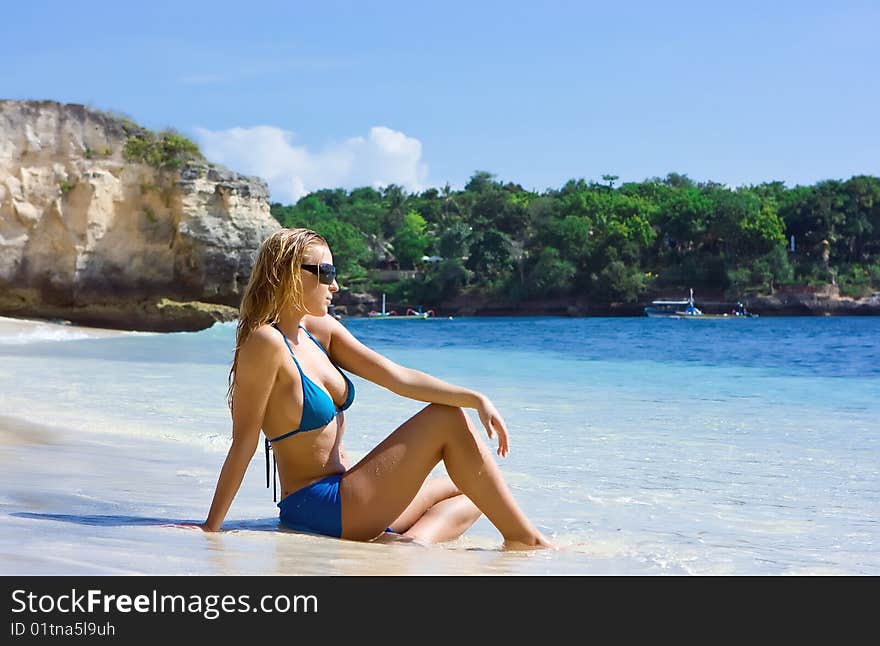 Blonde girl relaxing in water on the beach