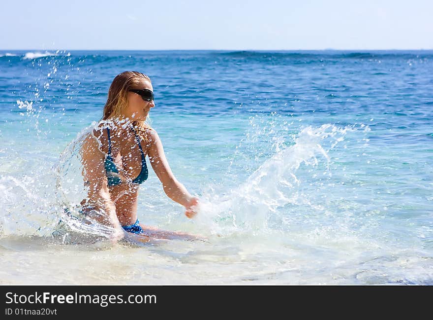 Girl Making Splashes In The Sea