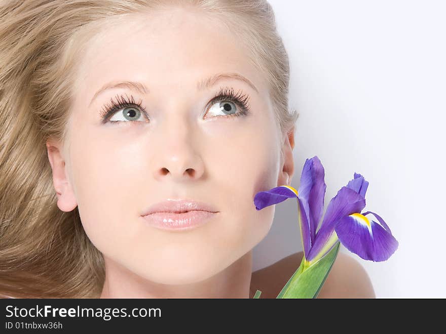 Close-up beautiful young fresh purity blonde lady with flower. Close-up beautiful young fresh purity blonde lady with flower