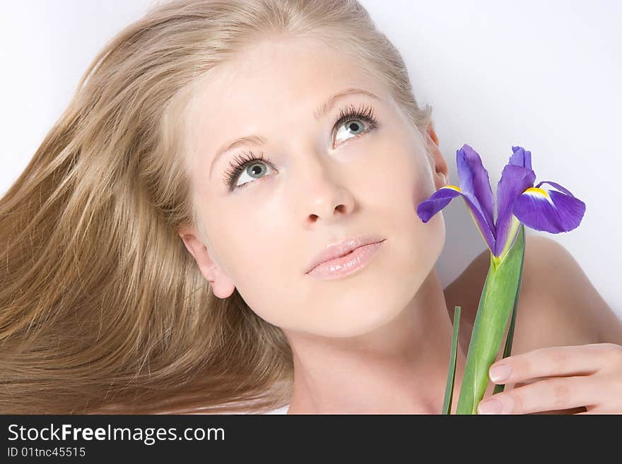 Close-up beautiful young fresh purity blonde lady with flower. Close-up beautiful young fresh purity blonde lady with flower