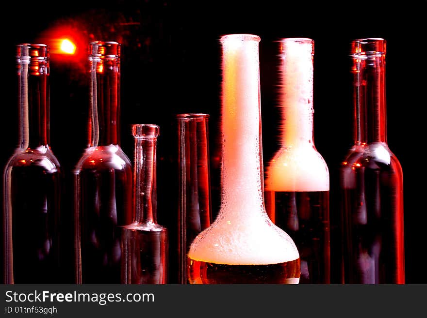 A nice set of different shaped bottles on a black background. A nice set of different shaped bottles on a black background