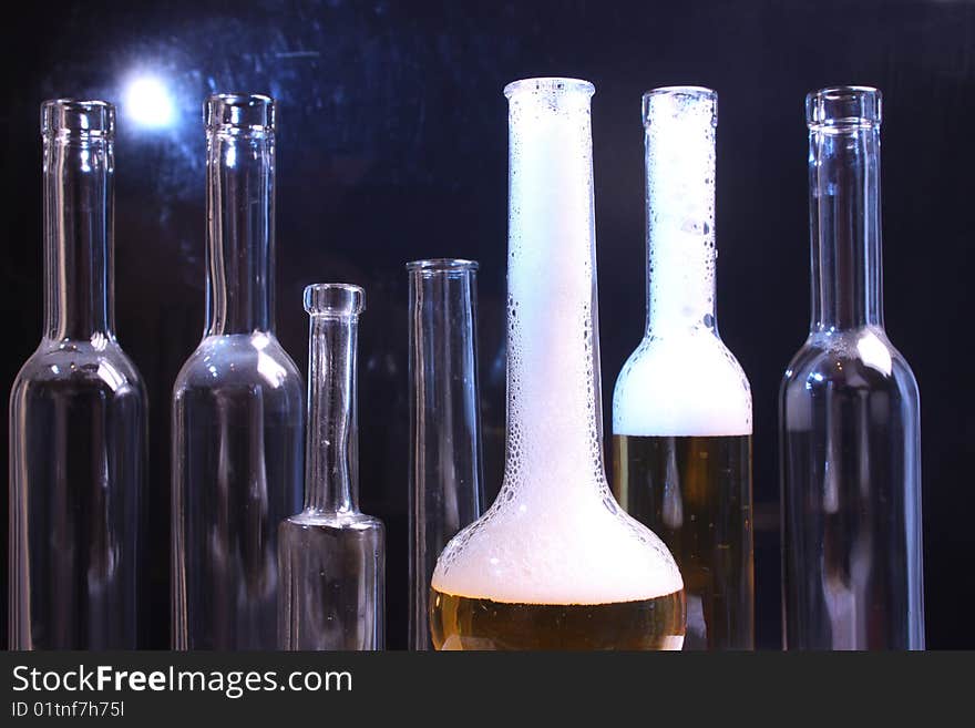 A nice set of different shaped bottles on a black background. A nice set of different shaped bottles on a black background