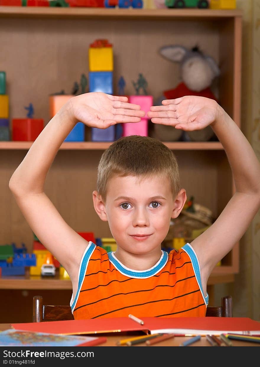 The boy of 7 years is engaged in a children's room