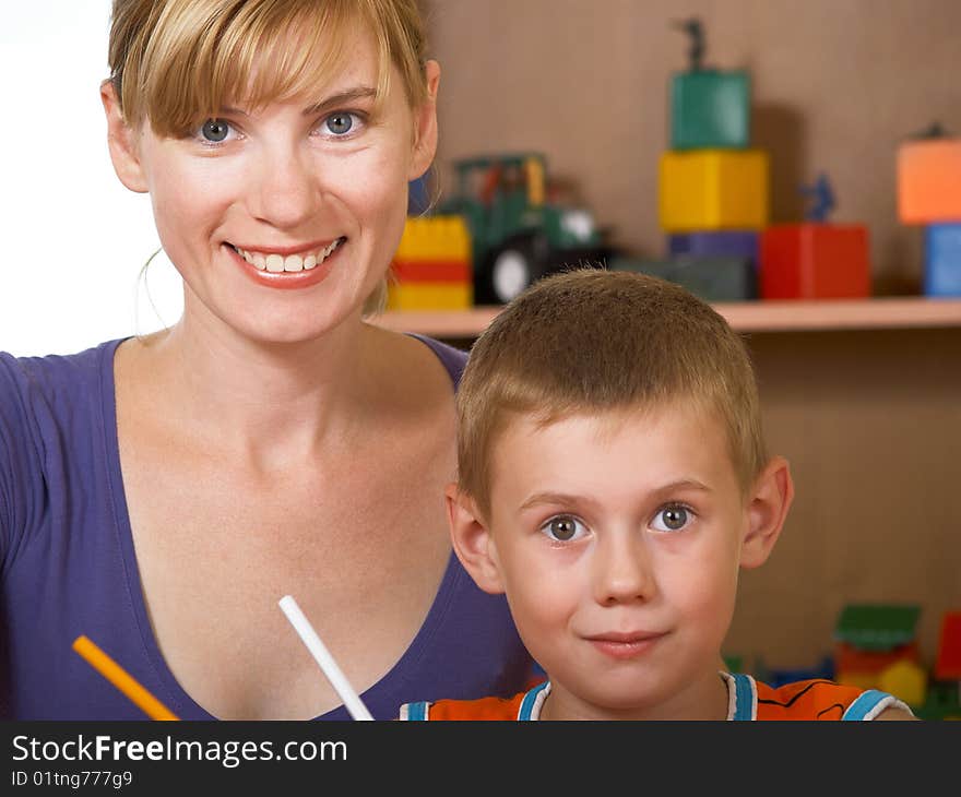 The mum with son is engaged in a children's room