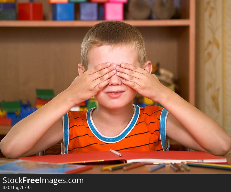 The boy of 7 years is engaged in a children's room