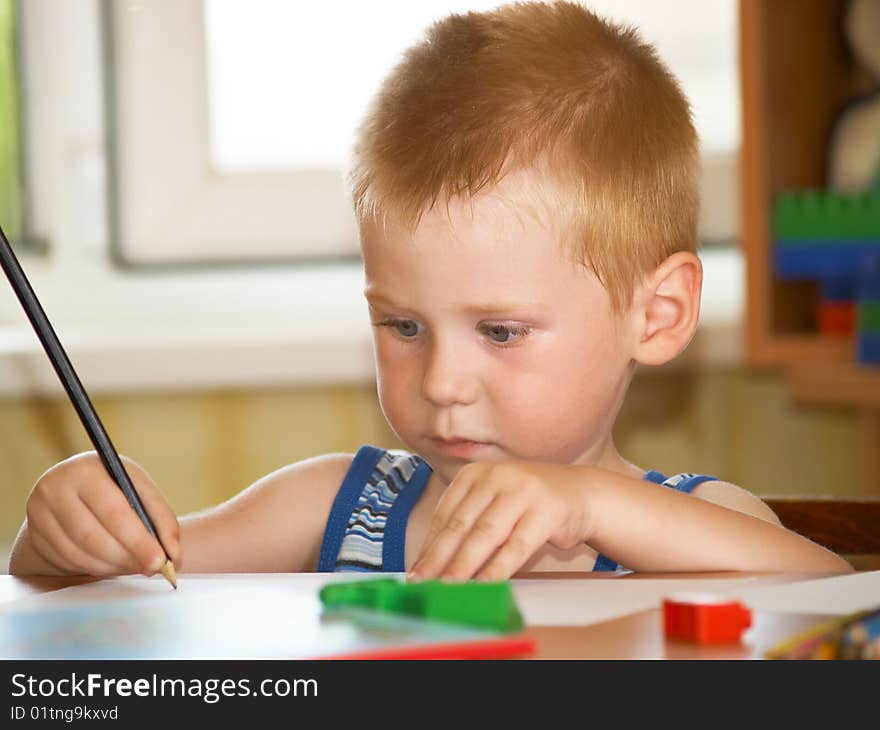 The boy of 2 years is engaged in a children's room