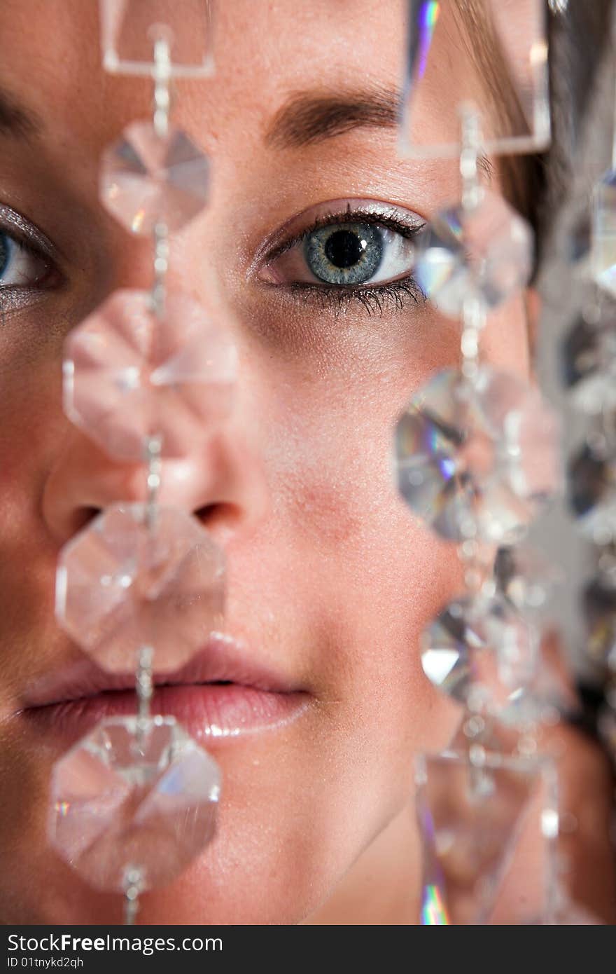 Young attractive Woman eyes closeup with glitter chain