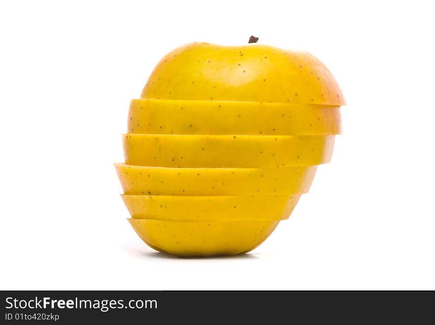 Sliced yellow apple on studio white