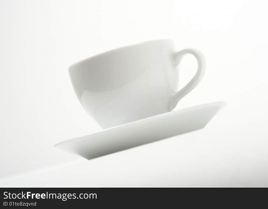 White cup and saucer on white background