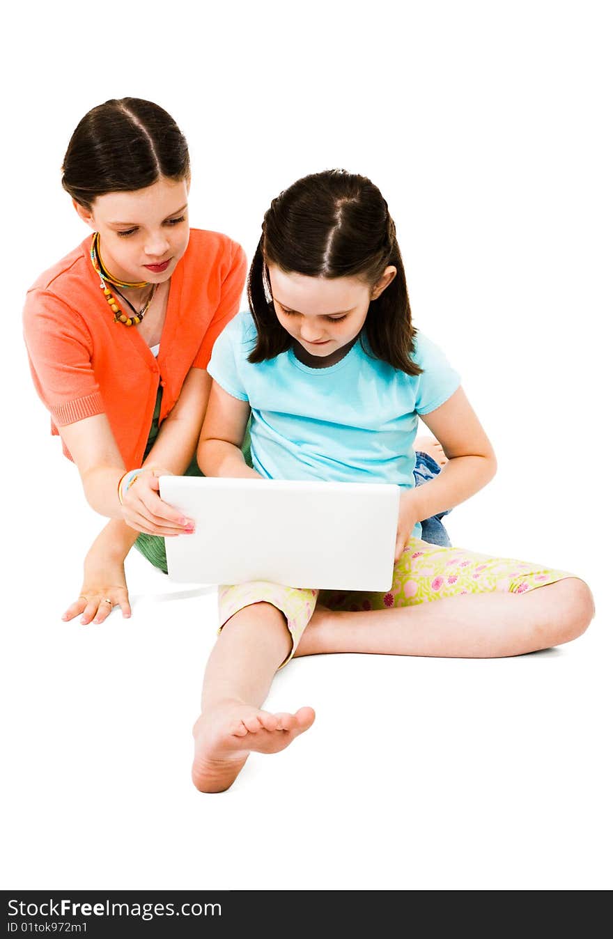 Girls using a laptop isolated over white