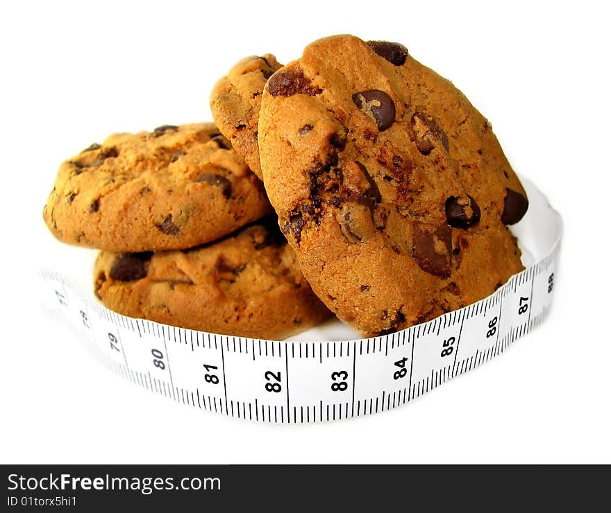 Chocolate cookies wrapped in a measuring tape showing temptation vs. diet. Chocolate cookies wrapped in a measuring tape showing temptation vs. diet