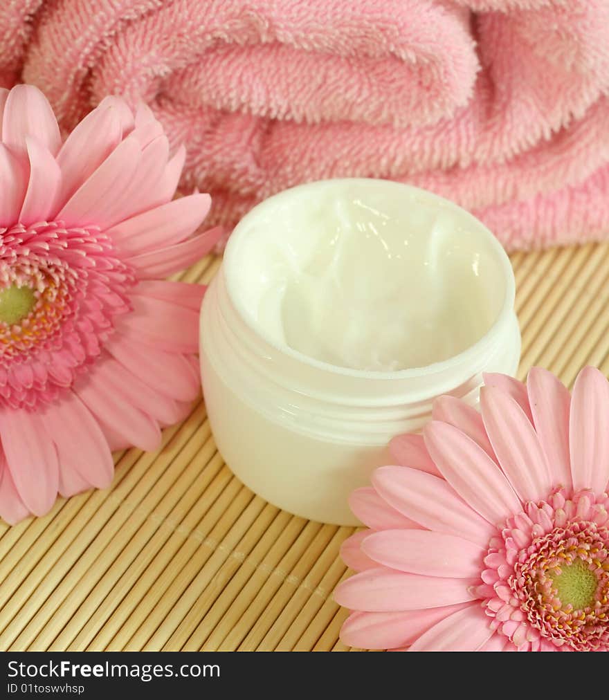 Face cream, towel and flowers.