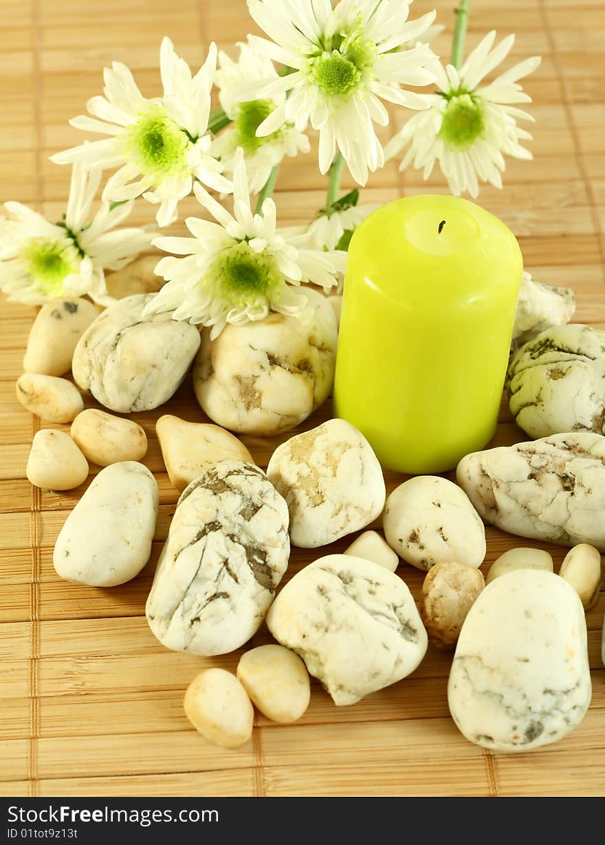 Candle, stones and flowers.