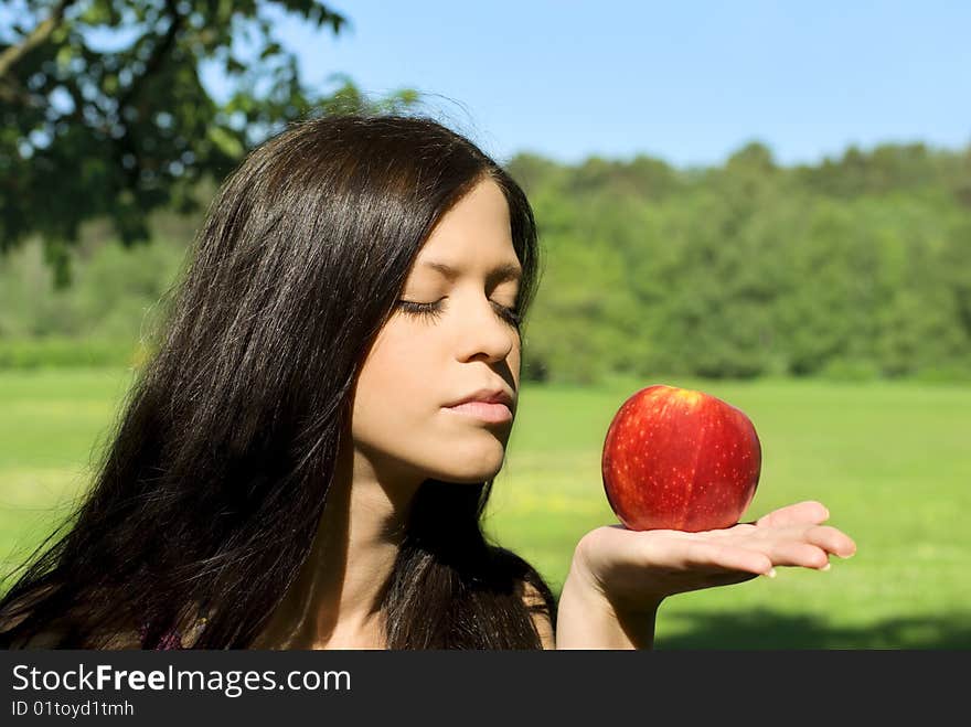 Pretty young woman with red apple