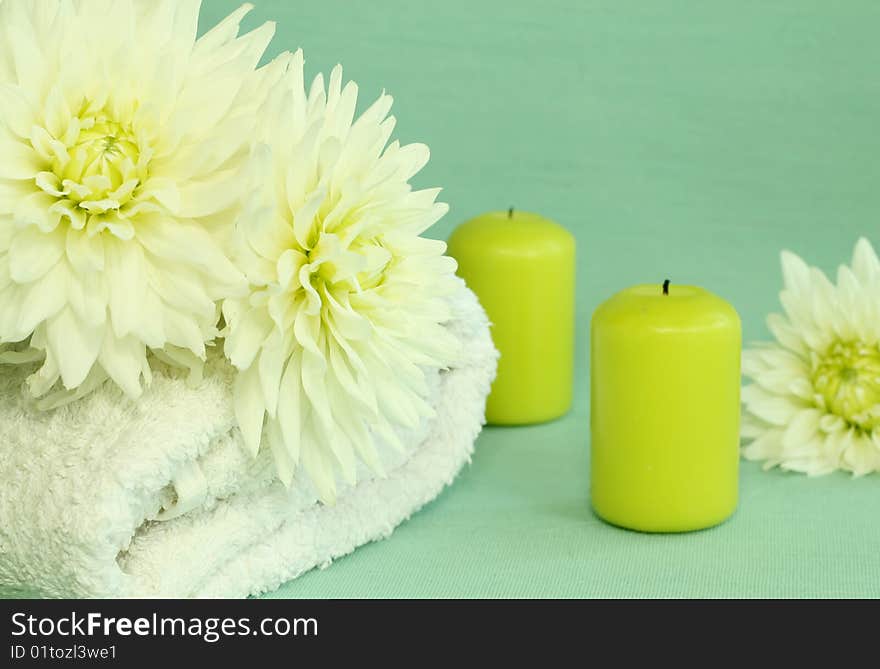 Spa essentials. Towel, candles and flowers.