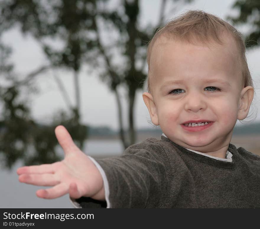 Toddler boy reaching for something just out of his reach and looking a bit distressed. Toddler boy reaching for something just out of his reach and looking a bit distressed