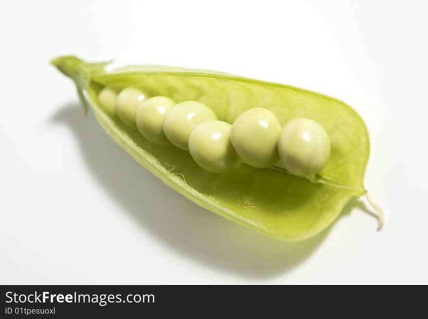 Pods of green peas on white background