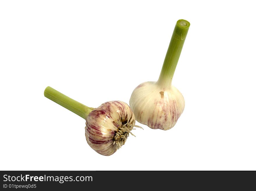 Two ripe garlics over a white background