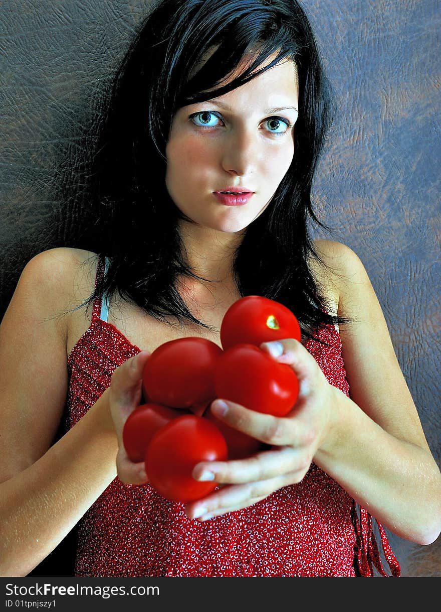 Beautiful Girl Holding Red Tomatoes.