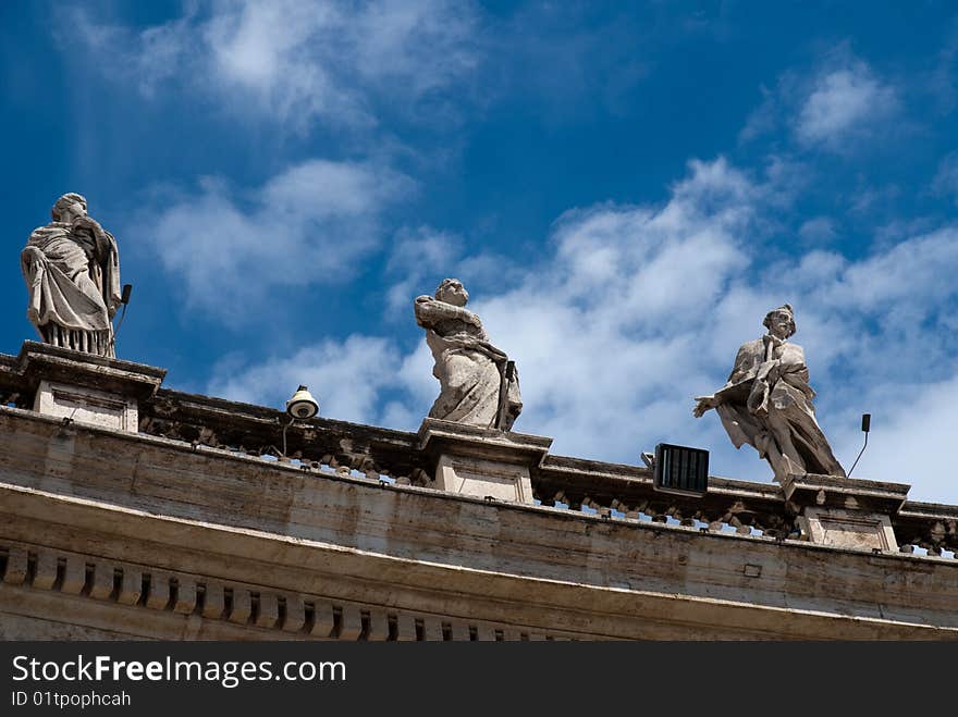 Religious Catholicism sculpture on roof against blue sky. Religious Catholicism sculpture on roof against blue sky