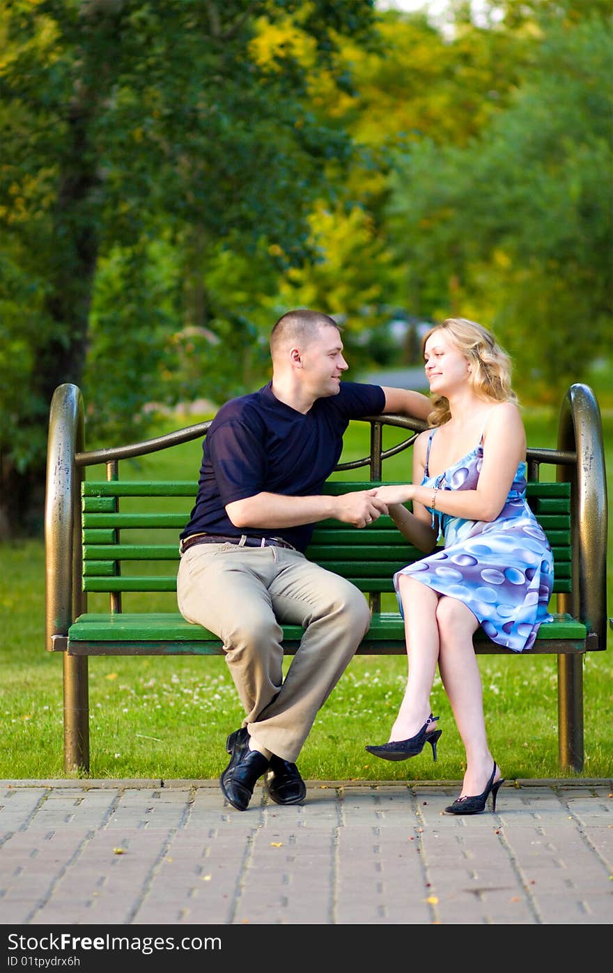 Couple in love sitting at a bench