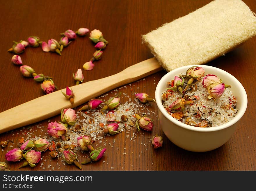 Still life with bath salt, loofah, and roses in a love heart. Still life with bath salt, loofah, and roses in a love heart