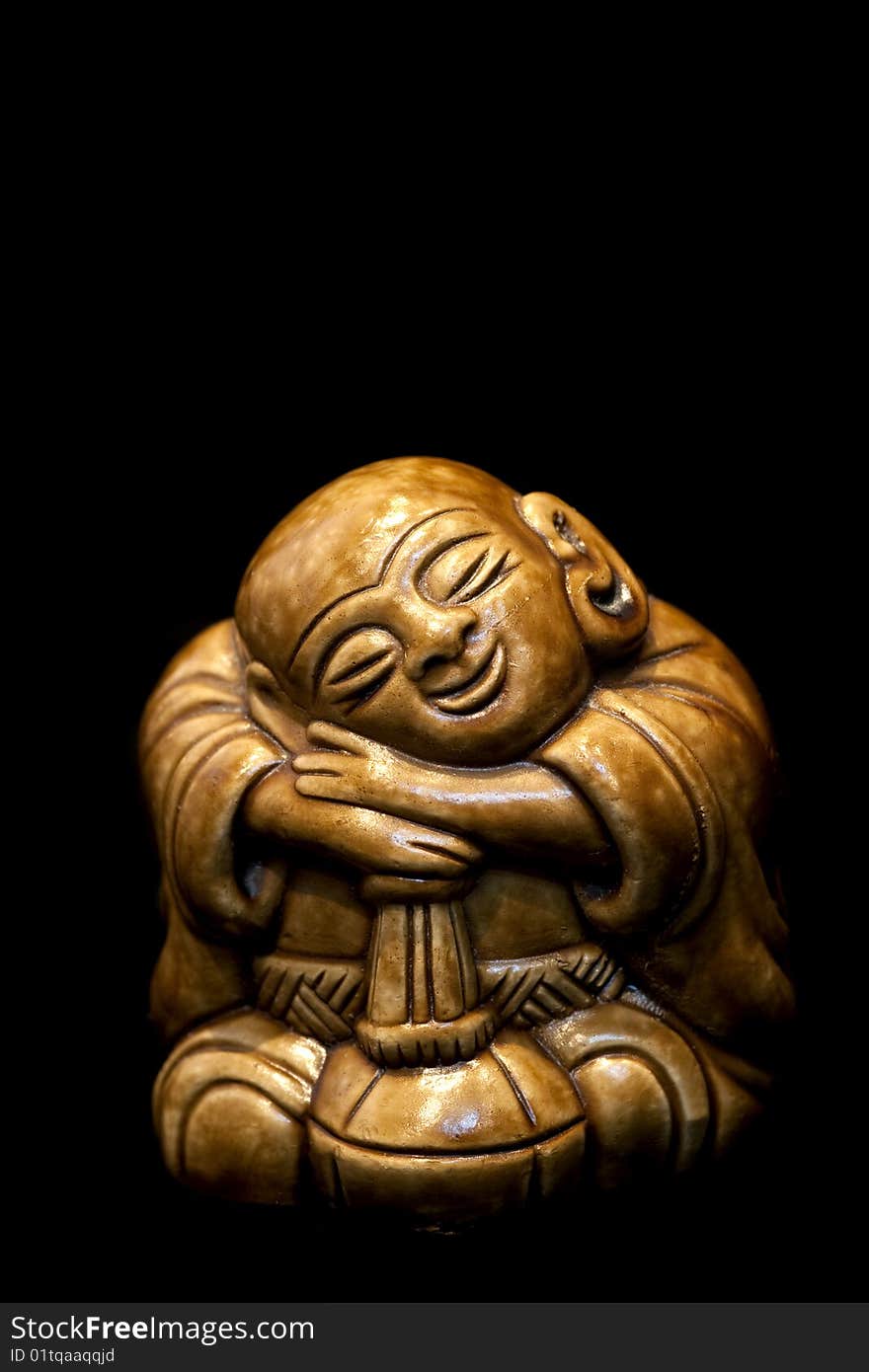 Wooden statue isolated on black. Wooden statue isolated on black