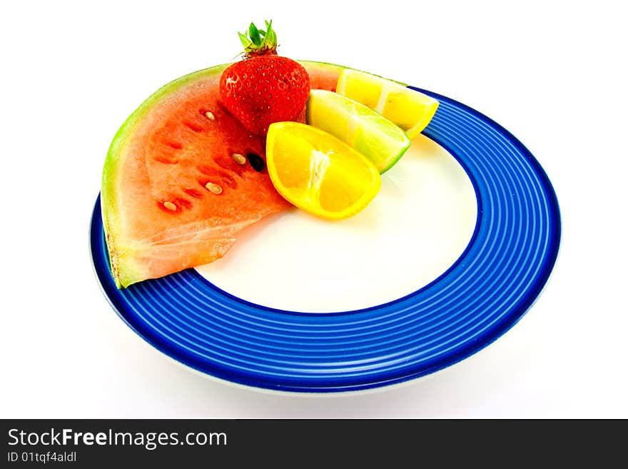 Slice of juicy watermelon with lemon, lime and orange halves a red ripe strawberry on a white background. Slice of juicy watermelon with lemon, lime and orange halves a red ripe strawberry on a white background