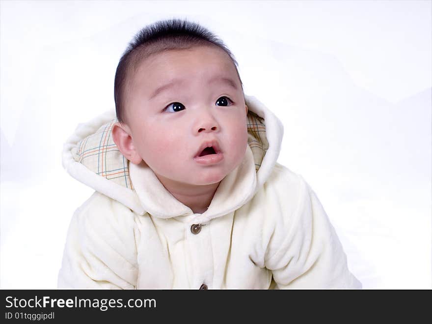 A baby sitting on the white background. A baby sitting on the white background