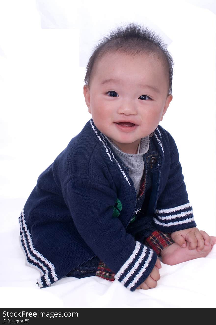 A baby sitting on the white background. A baby sitting on the white background