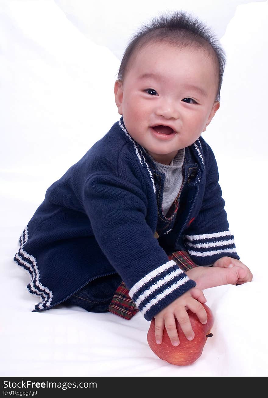 A baby sitting on the white background. A baby sitting on the white background