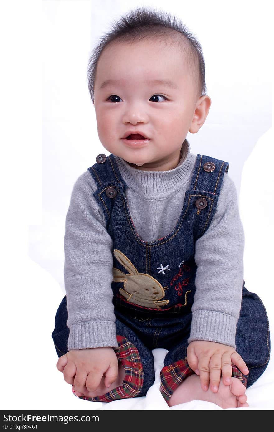 A baby sitting on the white background. A baby sitting on the white background