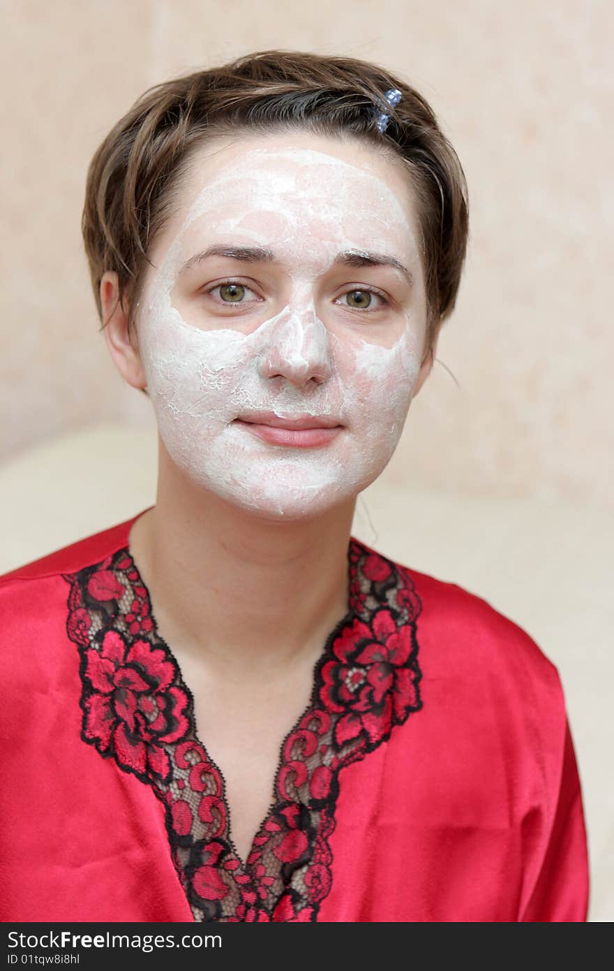 The housewife with face mask at home