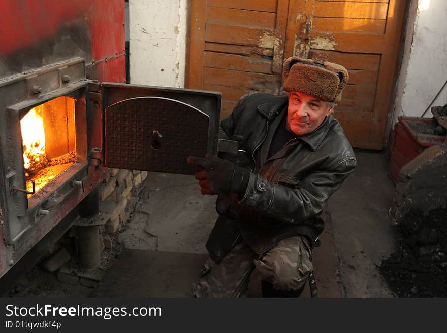 The stoker poses in a stokehole, winter. The stoker poses in a stokehole, winter