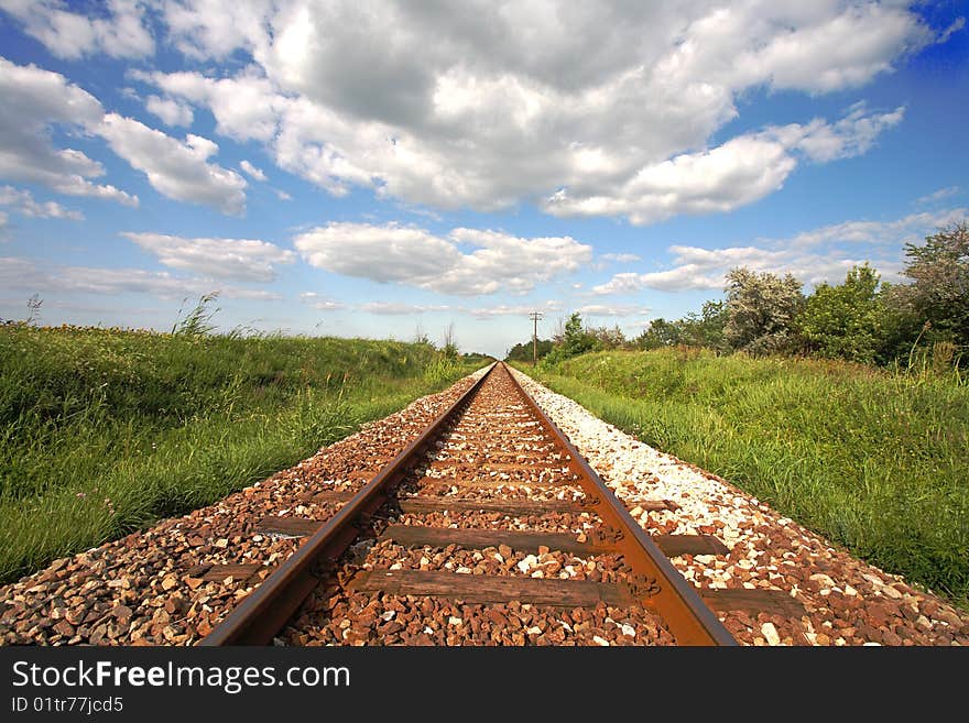 Railway tracks disappearing into distance.