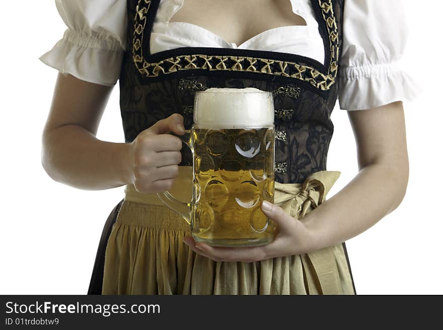 Bavarian Woman in Dirndl holds Beer stein in front of breast at Oktoberfest. Bavarian Woman in Dirndl holds Beer stein in front of breast at Oktoberfest