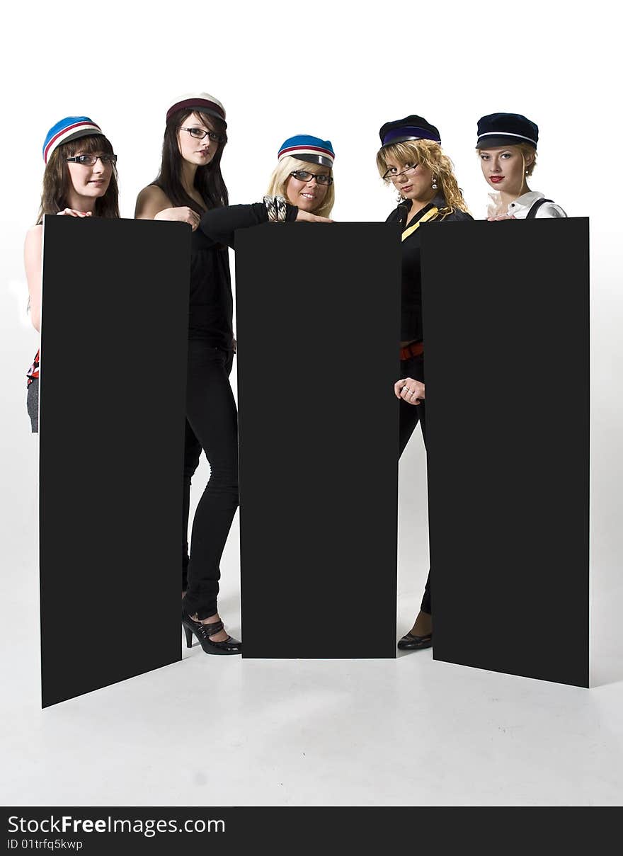 Team of five young women in generic university caps holding three blank posters. Team of five young women in generic university caps holding three blank posters.